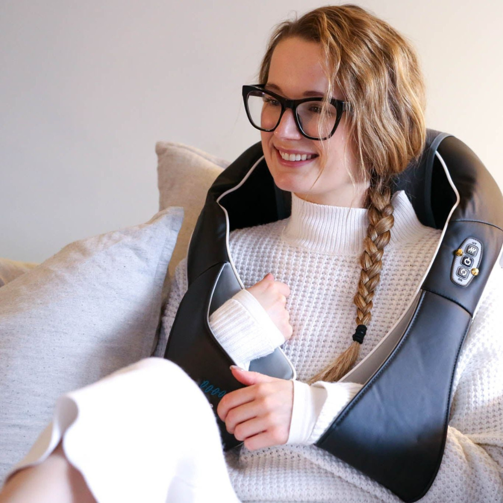 Woman relaxing on the couch with the Backplus 3 n 1 massager.