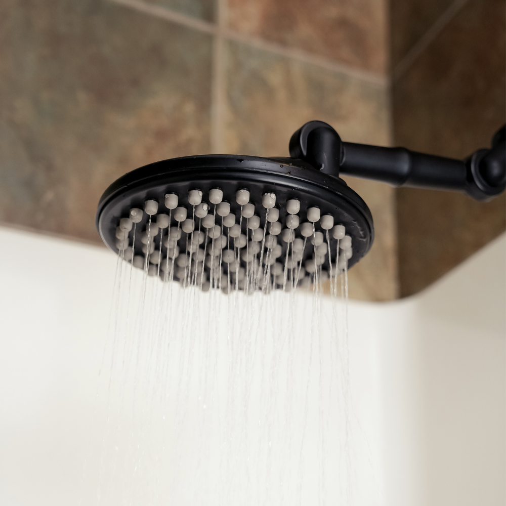 ShowerMe® Rain Shower Head in Matte Black spraying water in rainfall position