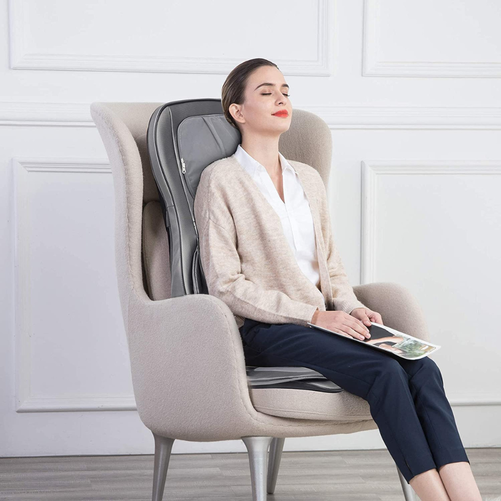 Woman using the BACKplus® Shiatsu Neck and Back Massager With Air Compression Chair Cushion on chair