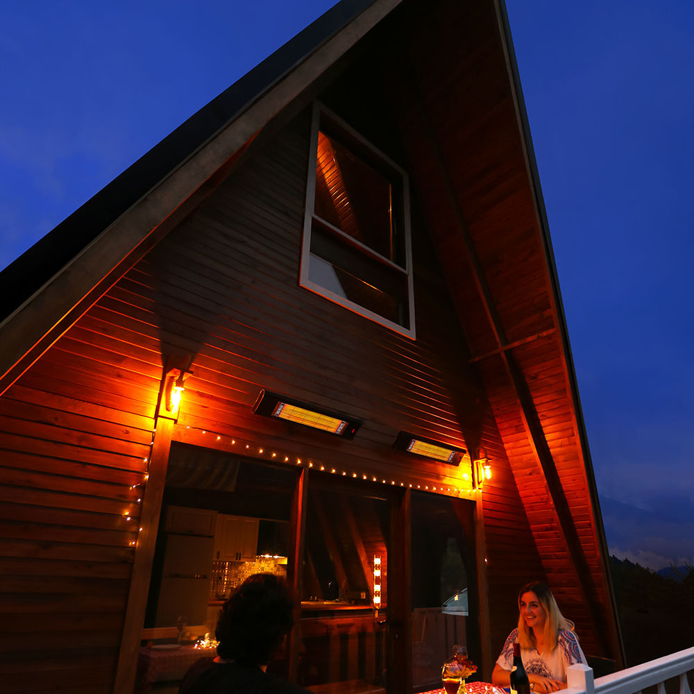 Couple enjoying the Veito® Aero S 1500W that is mounted on outside of house by the patio