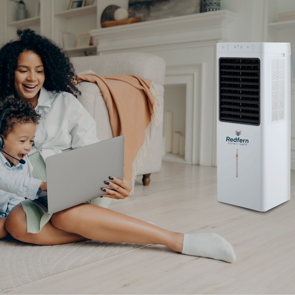 Mom and son sitting in front of the iQ Pure Breeze EXTRA Large Air Cooler