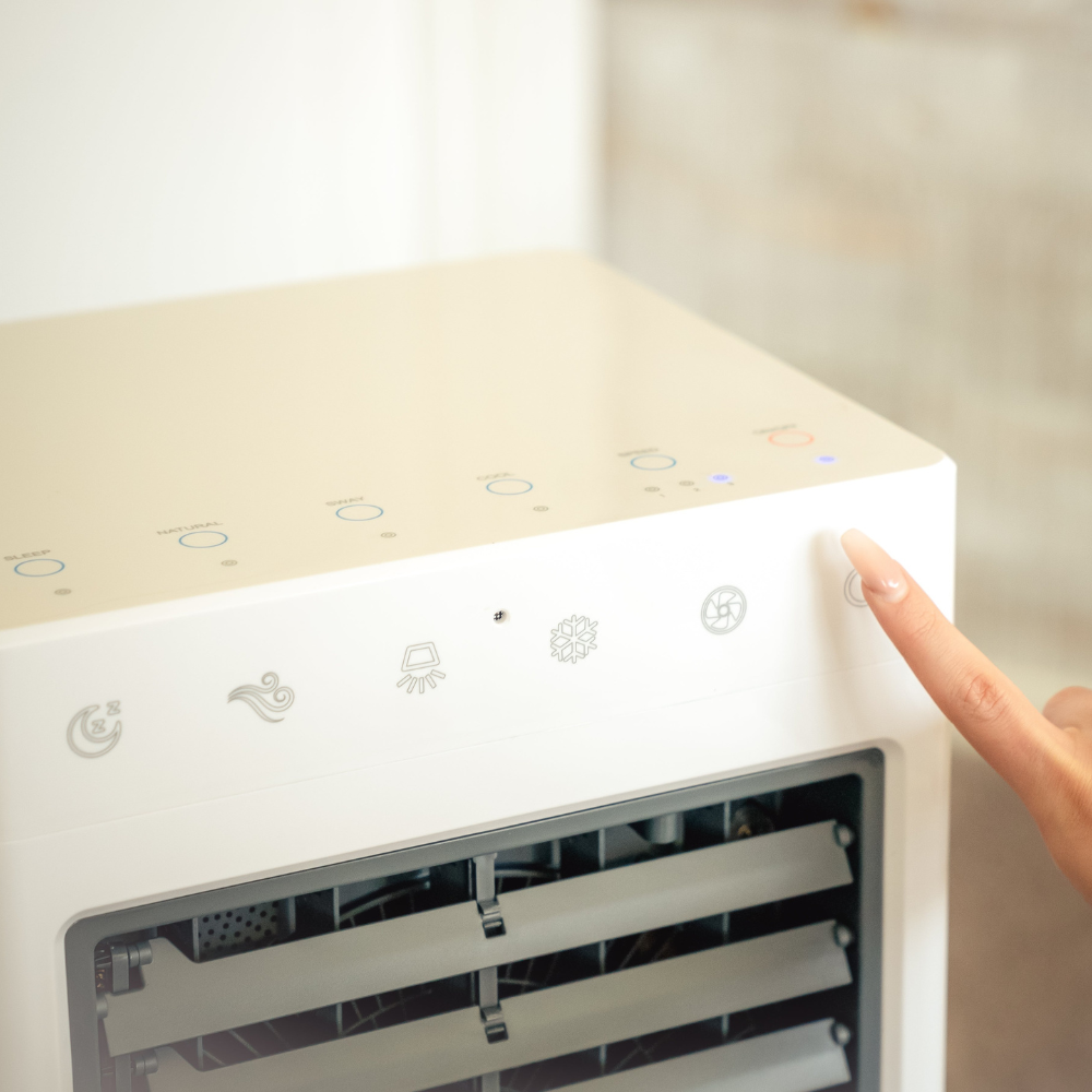 Close up of women pressing button on the iQ Pure Breeze Air Cooler Evaporative Cooler control panel