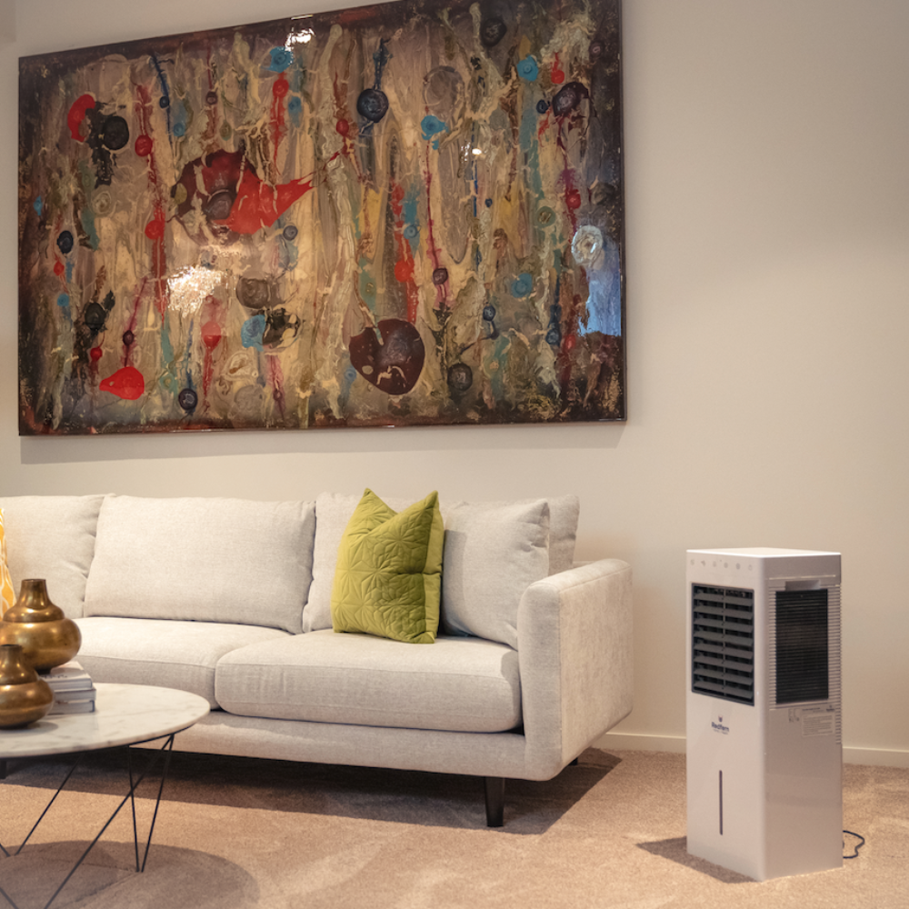 iQ Pure Breeze Air Cooler beside couch in living room
