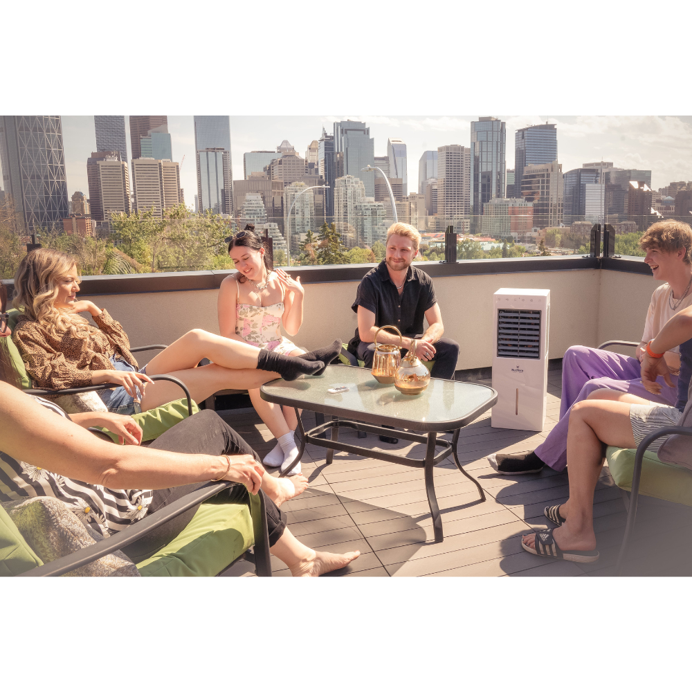 Friends on a roof patio with the iQ Pure Breeze Air Cooler Evaporative Coolers iQ Pure Breeze running in the background.