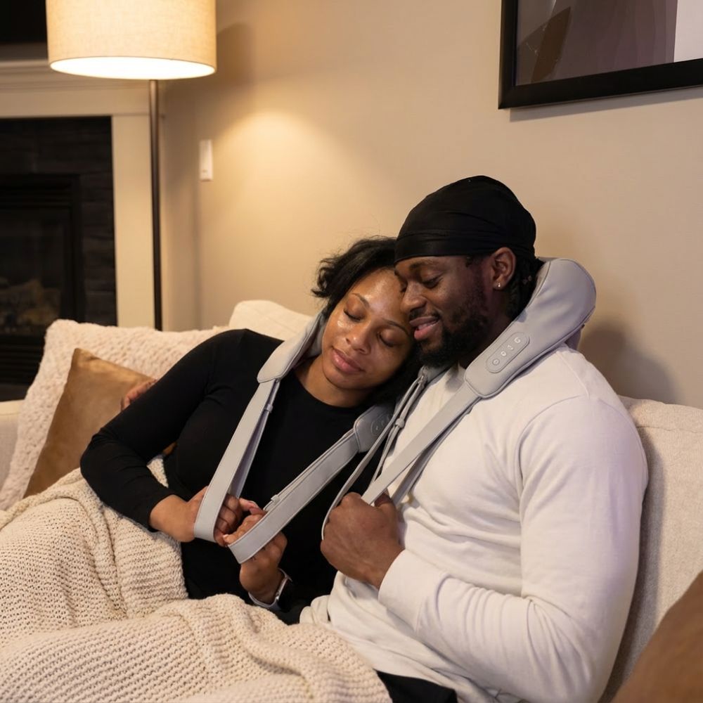 couple sitting on the couch relaxing while using the BACKplus Cordless Platinum massager
