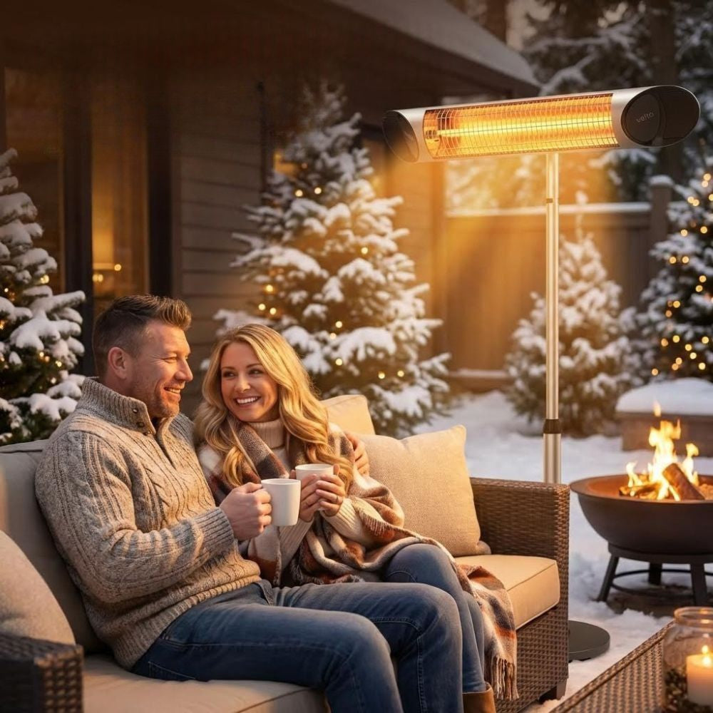 Silver Veito Heater in the snow with a couple on patio furniture 