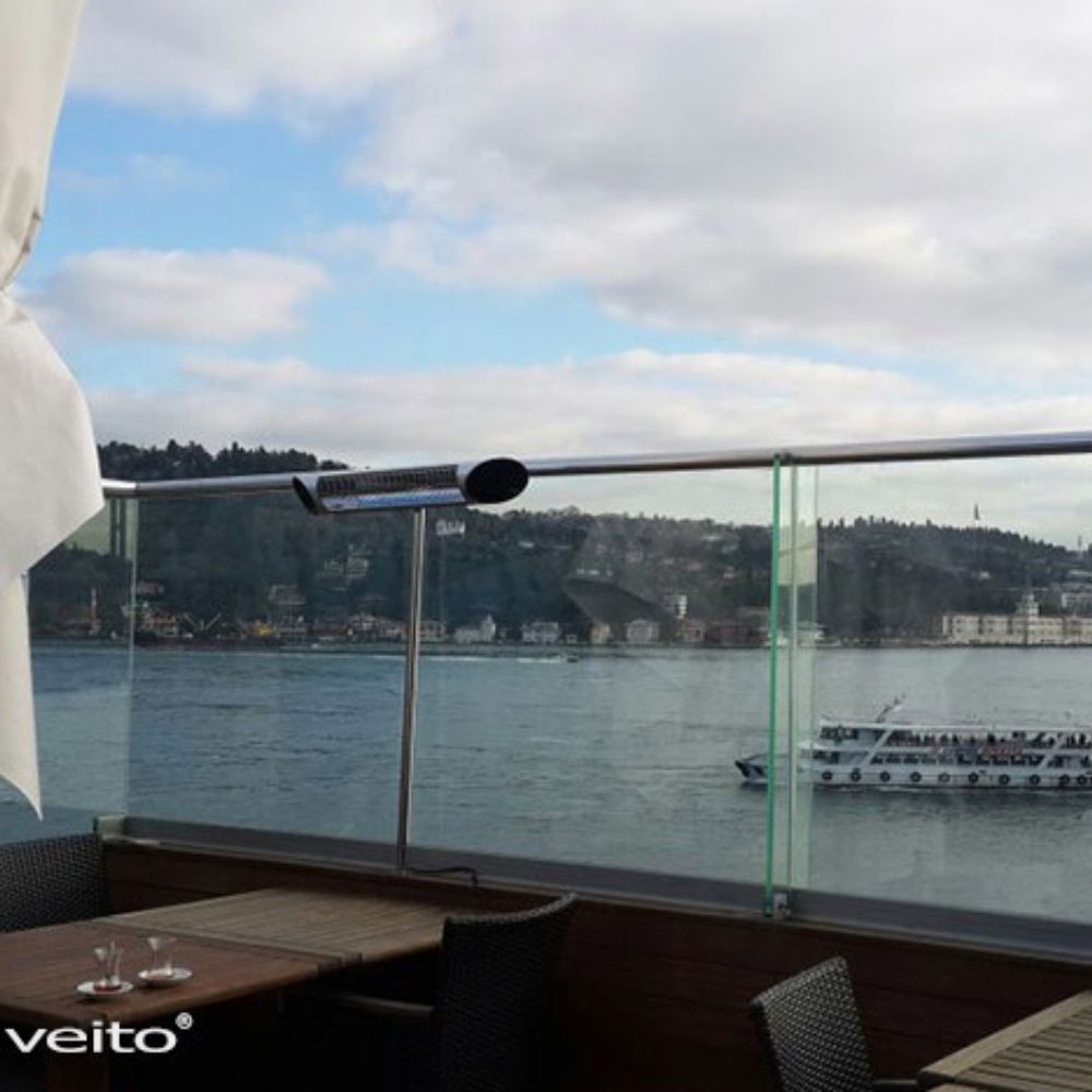 Veito Blade silver mounted on glass railing with boat in the background